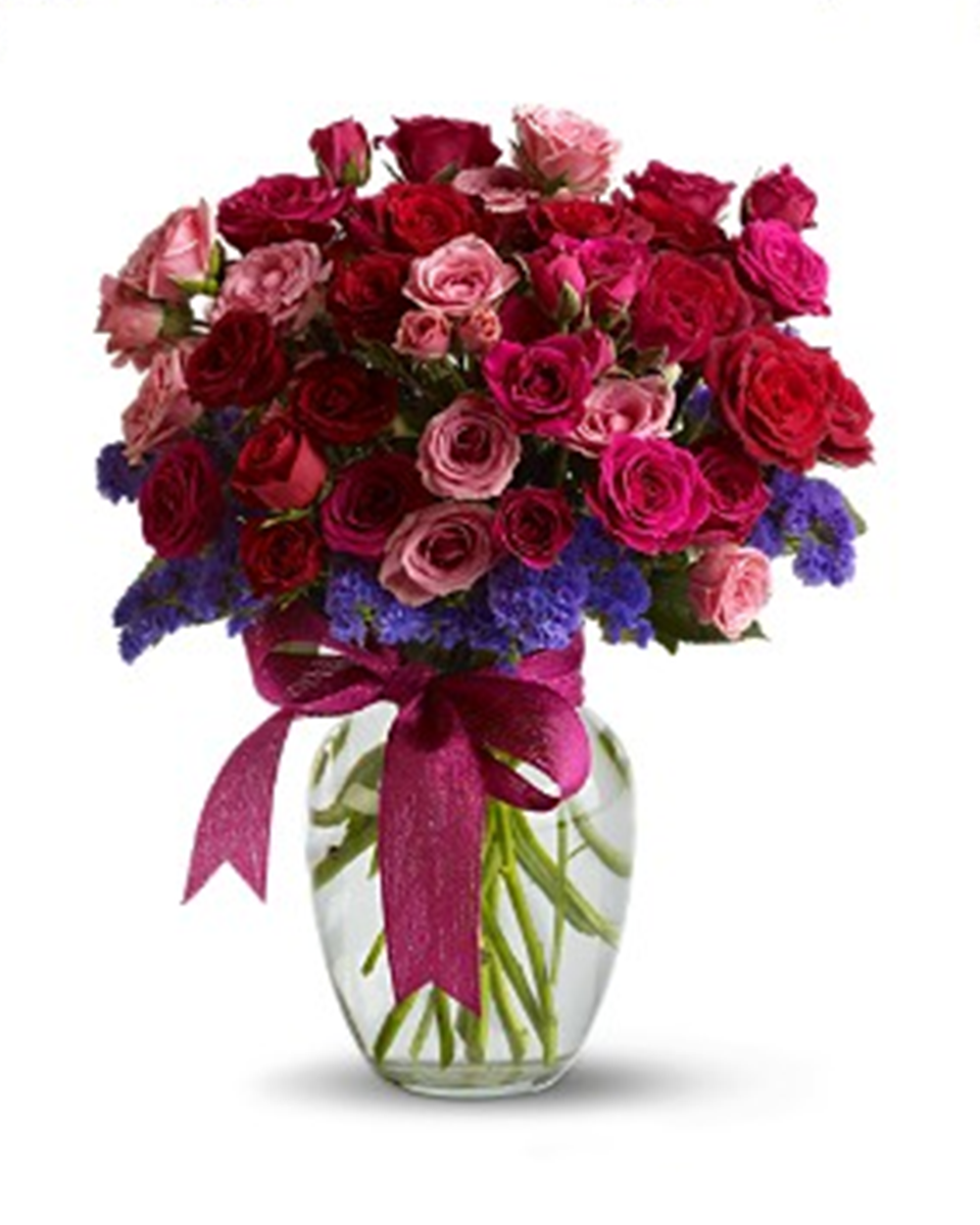 Fabulous Flirt Fabulous Flirt - Standard Fabulous Flirt - This gloriously rich array of red and pink roses radiates a lot of visual heat.  Delivered in a classic clear glass vase, tied with a hot pink ribbon, it’s sure to stir some very warm feelings.  Approximately 15 inches tall by 13 inches wide.