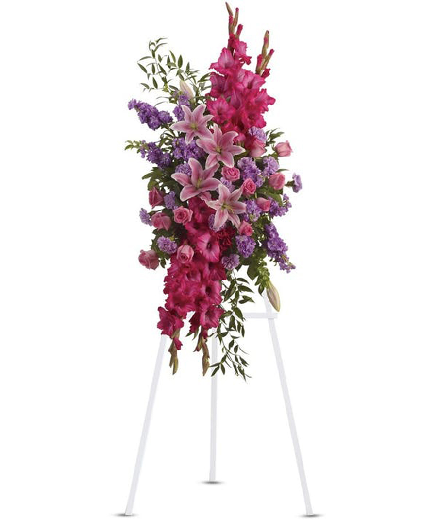 Loving Thoughts Tribute Standard Gorgeous flowers such as pink roses, oriental lilies and gladioli blend with purple stock, lavender carnations and fragrant greens. Approximately 22
