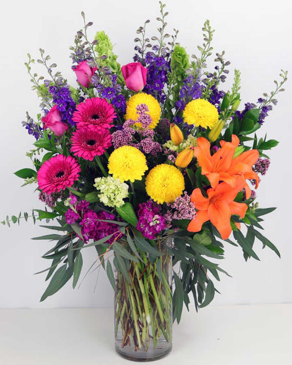 Razzle Dazzle Deluxe Send the party anywhere with this stunning arrangement of premium florals in bright, bright colors.
DELIVERY: Every order is hand-delivered direct to the recipient. These items will be delivered by us locally, or a qualified, retail, local florist..
