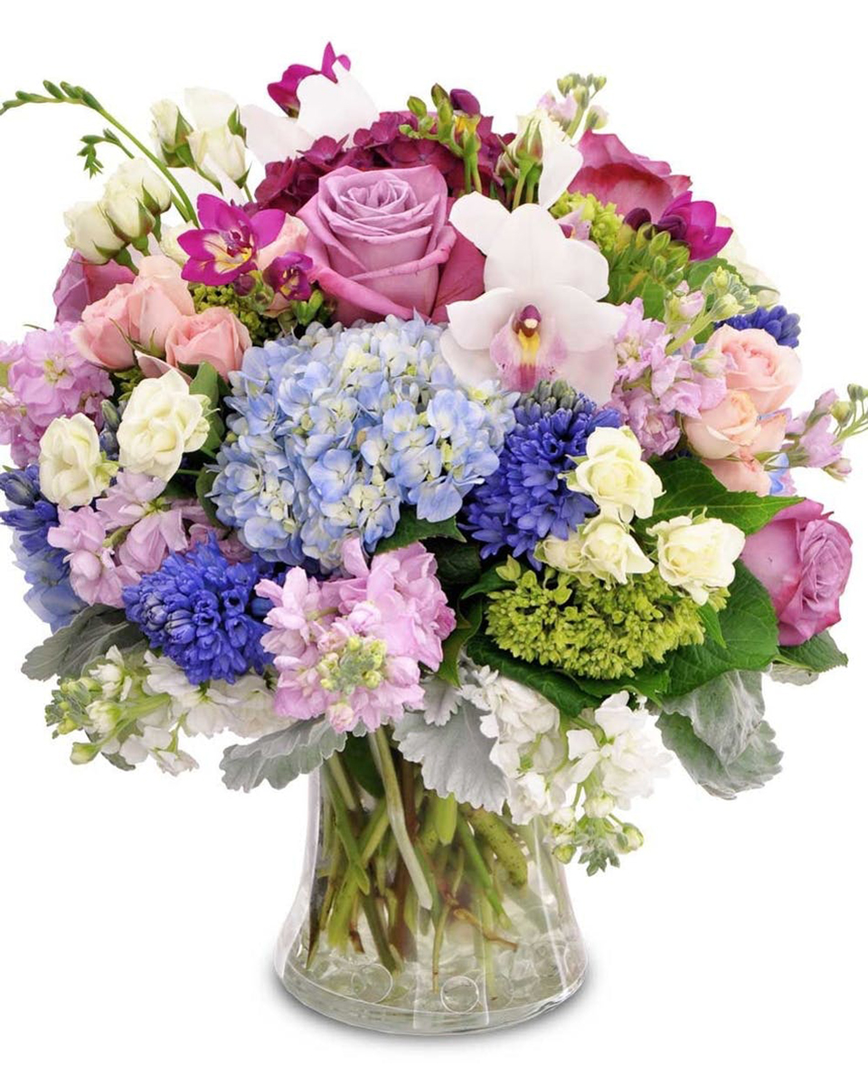 Garden Grove Standard Send an abundance of love with this stunning work of art comprised of premium floral varieties, including Hydrangea, Roses, Spray Roses, Orchids, Lavender and more! * Flowers & colors may vary slightly
DELIVERY: Every order is hand-delivered direct to the recipient. These items will be delivered by us locally, or a qualified retail local florist.