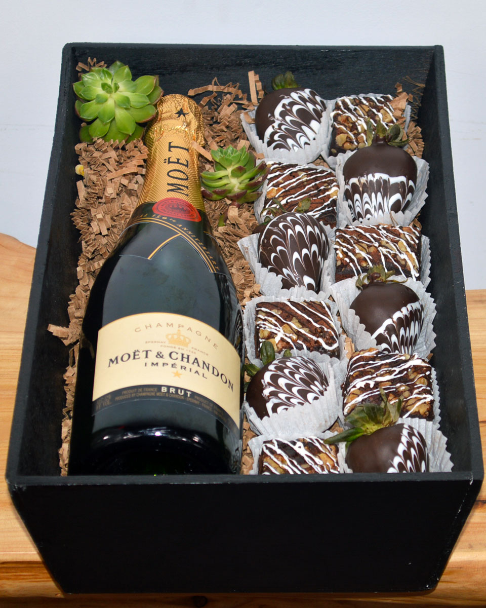 Champagne, Strawberries, And Brownies Moet & Chandon Champagne Fresh, Mouth watering chocolate brownies and irrisistable chocolate covered strawberries are paired with Wine or Champagne of your choice and crafted inside a gift wooden box. The brownies and chocolate covered strawberries are made daily by Babbette Bakery, one of Long beach's finest and oldest bakeries.
Please give at least a 24 hour notice when ordering these products. This helps insure the freshness and quality. The brownies contain nuts.
DELIVERY: Every order is hand-delivered direct to the recipient. This item is only deliverable to local areas serviced by Allen’s Flower Market Stores. 