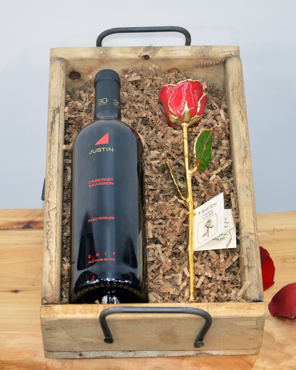 Wine and Gold Dipped Red Rose Crate With Justin Cabernet Sauvignon Justin Cabernet Sauvignon or Moet & Chandon Champagne is paired with a preserved Red Rose that is Dipped in Gold. The items are  elegantly arranged in one our rustic Wood Gift Crates.