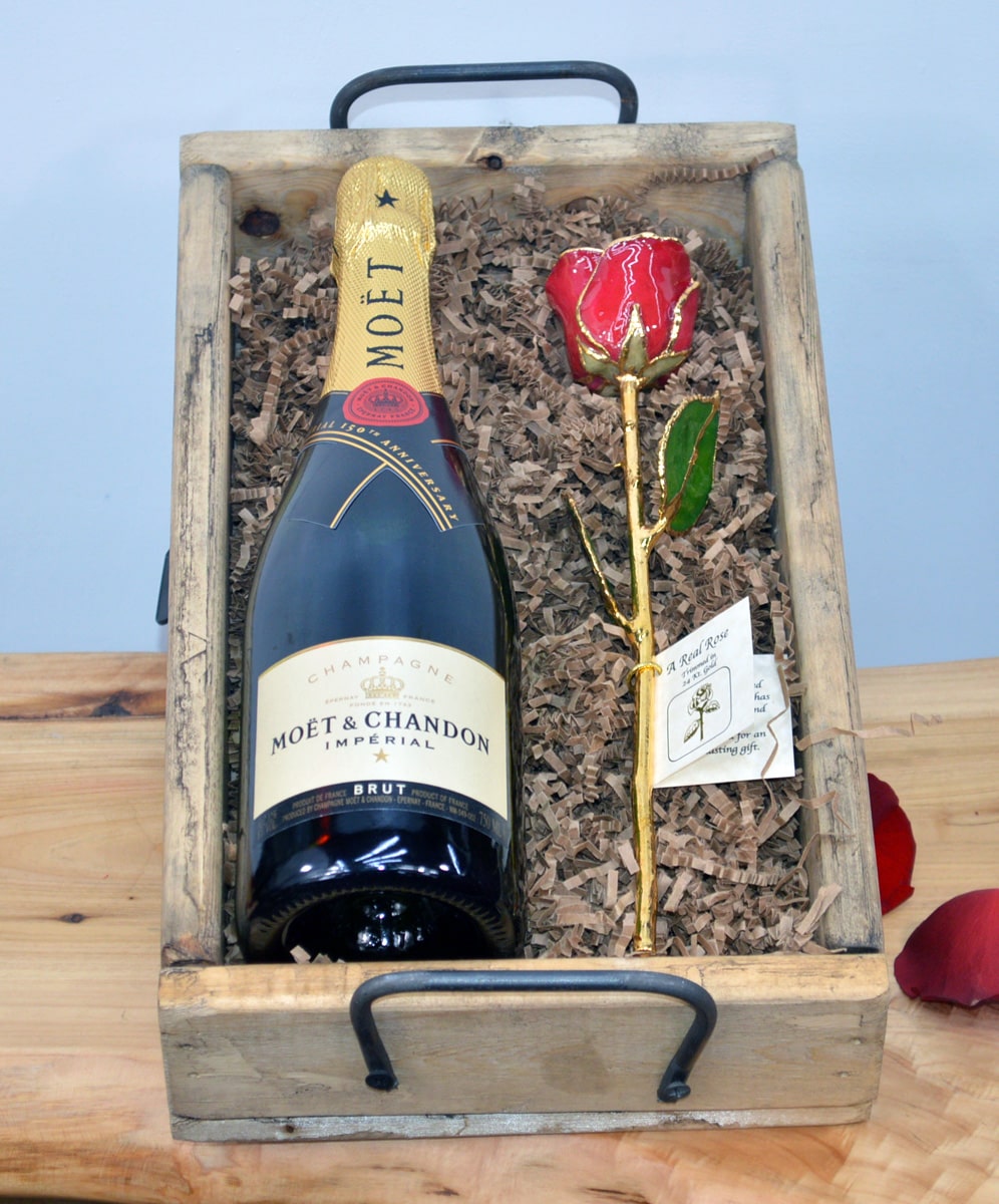 Wine and Gold Dipped Red Rose Crate With Moet & Chandon Champagne Justin Cabernet Sauvignon or Moet & Chandon Champagne is paired with a preserved Red Rose that is Dipped in Gold. The items are  elegantly arranged in one our rustic Wood Gift Crates.