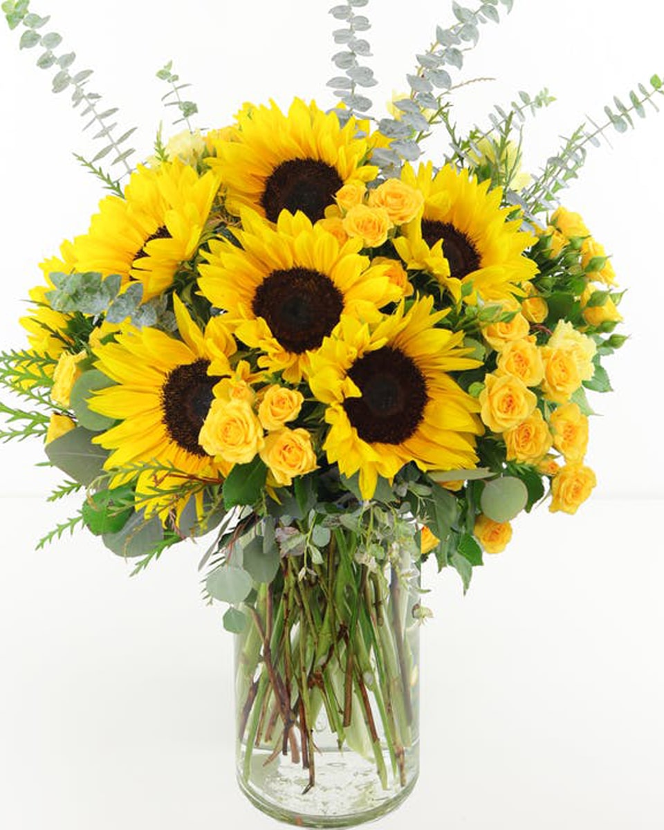 Let The Sun Shine  Standard California-grown sunflowers, bright yellow spray roses, multiple types of euclyptus and more.