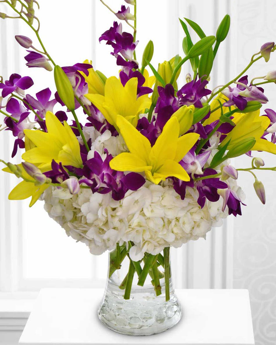 Hydrangea Elegance Standard A White Hhydrangea Base incorporates elegant sprays of Purple Dendrobium Orchids and Yellow Tiger Lilies.
DELIVERY: Every order is hand-delivered direct to the recipient. These items will be delivered by us locally, or a qualified retail local florist.
