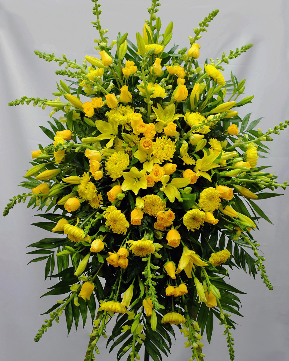 The Yellow Swan Premium Send your sincere condolences with our all-yellow standing spray. Crafted on a striking easel using the freshest available yellow roses, mums, snapdragons, lilies and more... Traditionally sent directly to the funeral home by family members or friends.
DELIVERY: Every order is hand-delivered direct to the recipient. These items will be delivered by us locally, or a qualified retail local florist.