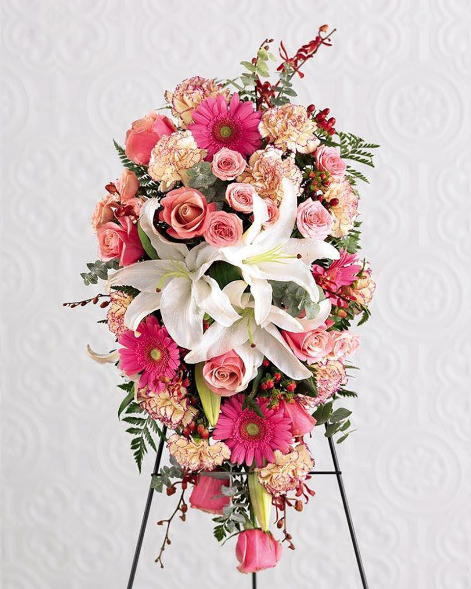 Field of Dreams Standard This beautiful sympathy spray in pretty pink tones features roses, Gerbera daisies, carnations, and similar seasonal fresh flowers, accented with a focal point of garden-fresh lilies.
DELIVERY: Every order is hand-delivered direct to the recipient. These items will be delivered by us locally, or a qualified retail local florist.
