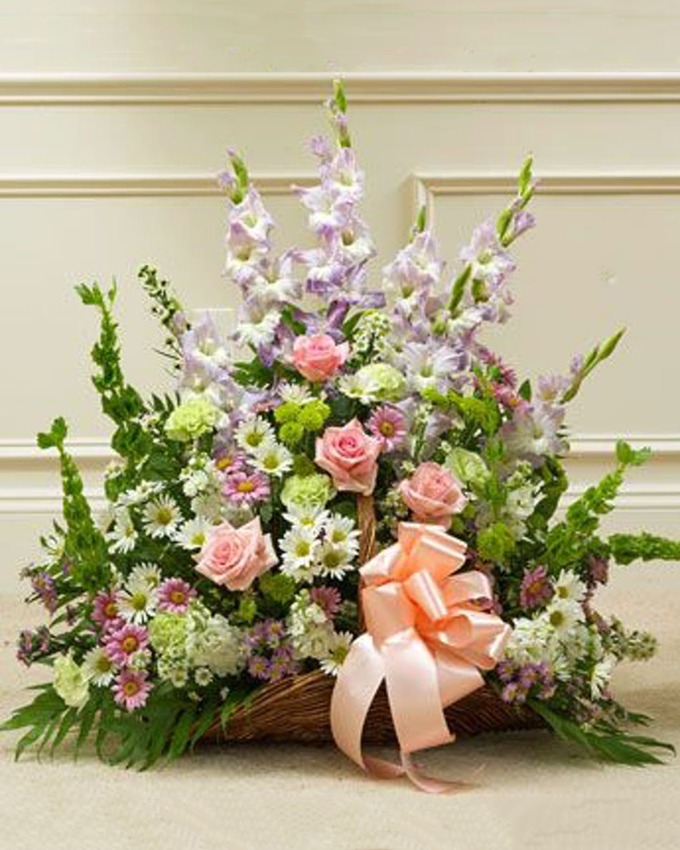 Fireside Basket in Pastels Standard Always beautiful, this fireside basket perfectly conveys your sympathy with a design of pastel-hued roses, gladiolas, and a variety of poms. Basket measures 21