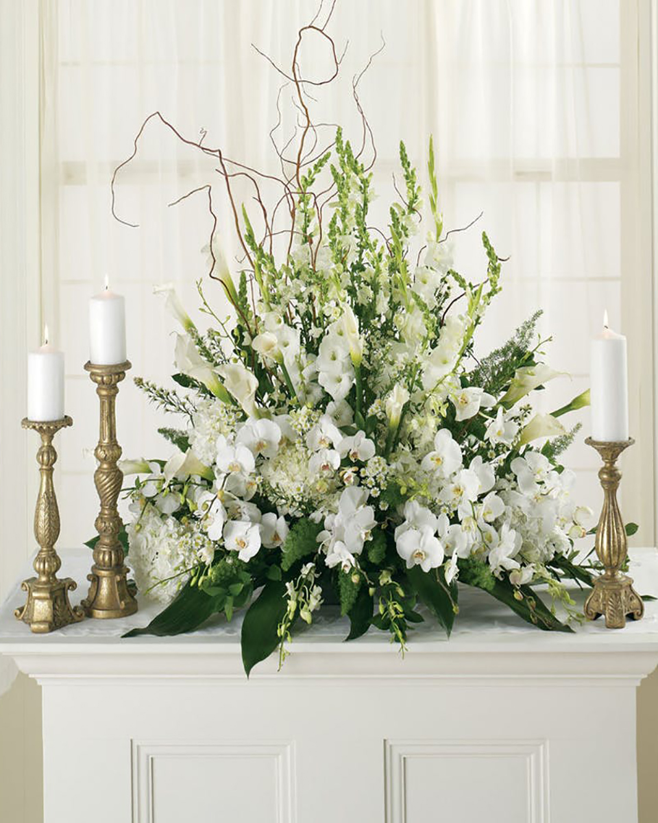 Lillywhite Lillith Standard White Snapdragons, White Gladiolus, White Hydrangea, White Philanopsis Orchids, White Dendrobium Orchids, White Calla Lillies, White Monte Casino, Curley Willow, and Ti Leaves are designed into a tall Altar Arrangement.
DELIVERY: Every order is hand-delivered direct to the recipient. These items will be delivered by us locally, or a qualified retail local florist.