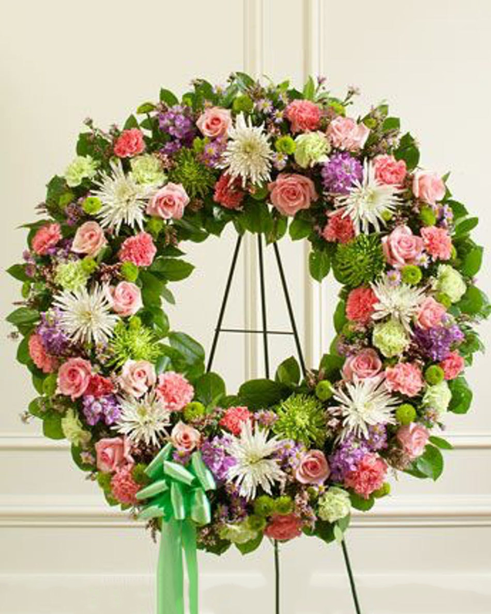 Spring Garden Wreath Deluxe (24 in) This elegant standing wreath features beautiful pastel tones created from garden florals. The is wonderful way to express your sympathy.*Large arrangement measures approximately 34