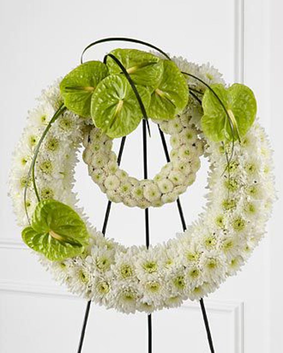 Rings of Earth Premium (30 Inch) A Standing Double Wreath on an Easel. The Outer Ring consists of White Cushion Poms with a Green Anthurium Spray at the top. The Inside Ring consists of White Button Poms. Bear Grass accentuates the Spray Of Anthuriums.
DELIVERY: Every order is hand-delivered direct to the recipient. These items will be delivered by us locally, or a qualified retail local florist.
