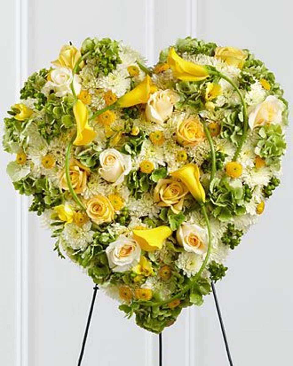 Heart of Gold Standard (18 Inch) Yellow and White Roses, White Cushion Pom Poms, Yellow Dot Poms, and assorted Greens comprise this solid Heart standing on an easel.
DELIVERY: Every order is hand-delivered direct to the recipient. These items will be delivered by us locally, or a qualified retail local florist.