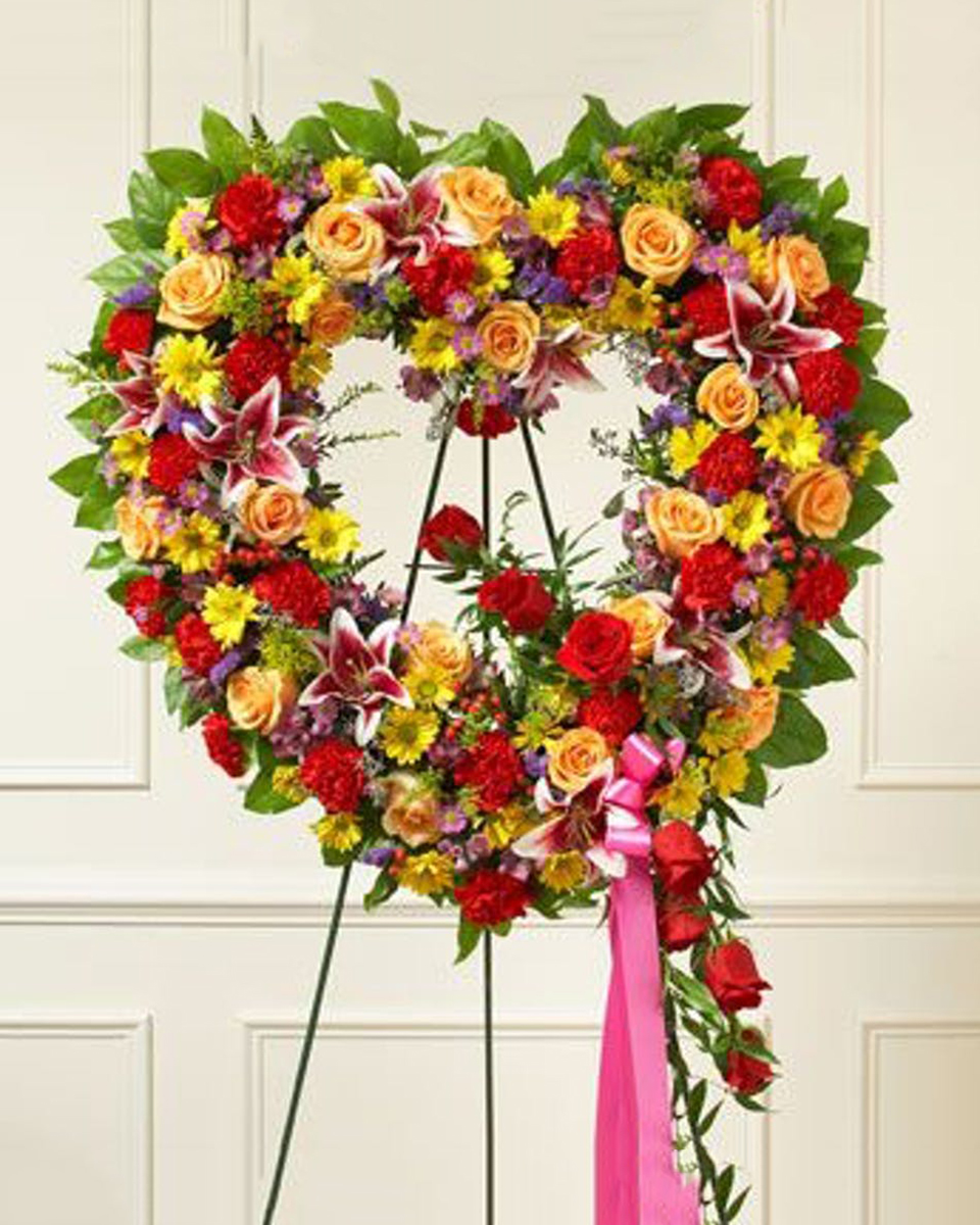 Summers Garden Open Heart Standard (18 Inch) Summer flowers such as roses, alstromeria and more combine to create a brilliant sympathy design. The open heart wreath is a popular expression of sympathy.
DELIVERY: Every order is hand-delivered direct to the recipient. These items will be delivered by us locally, or a qualified retail local florist.