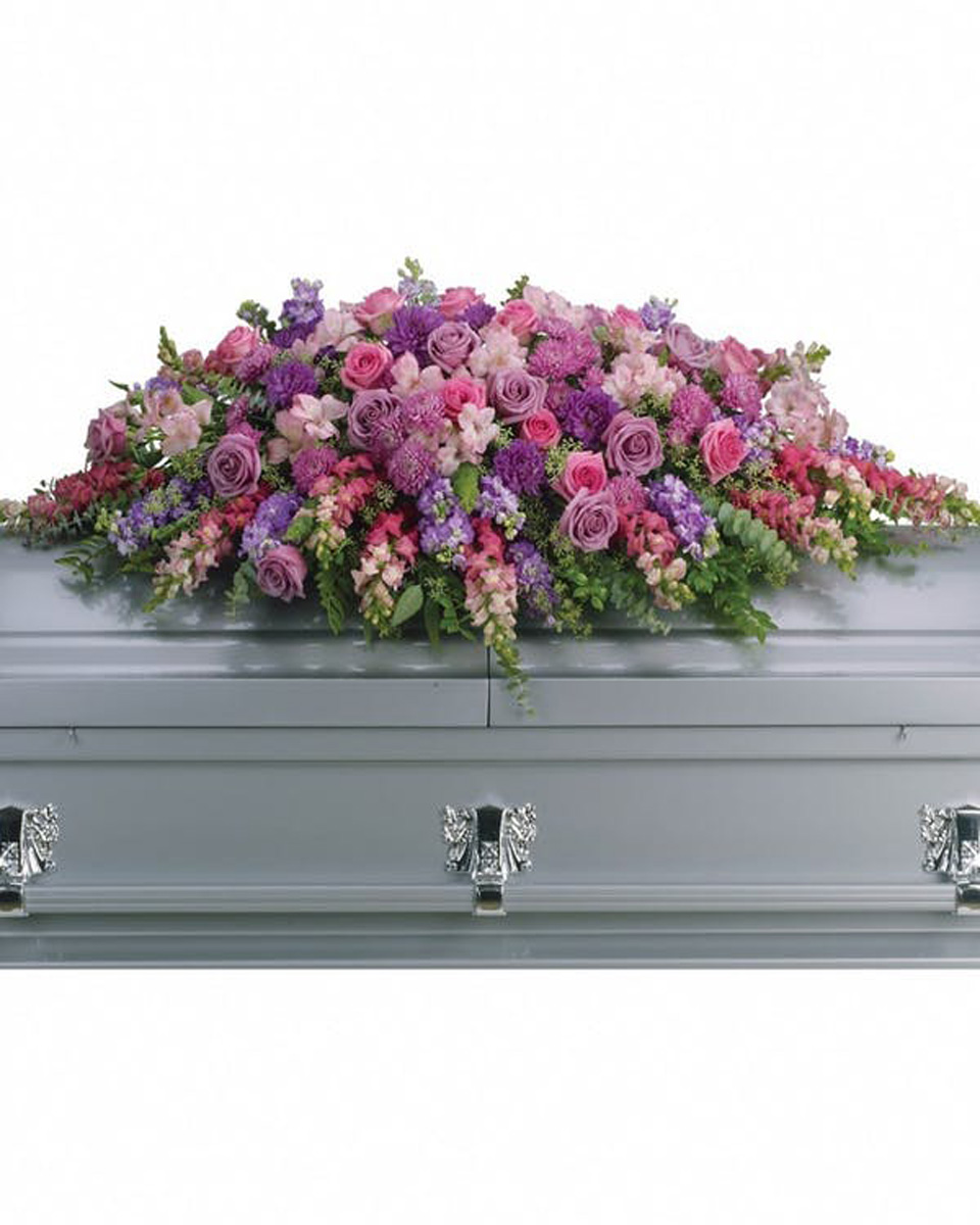 Lavender Tribute Casket Spray Standard-Half Casket Spray Lovely lavender and pink roses, snapdragons, alstroemeria, chrysanthemums, fern, eucalyptus and more create this tribute that is overflowing with grace and love. Approximately 51