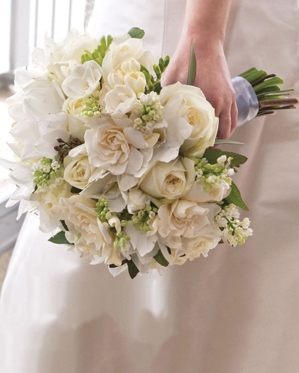 Roses and Gardenias Standard White Roses, White Freesia, Lily of the Valley, White Tulips, White Lilies, and Gardenias are crafted, then hand tied with Satin Ribbon, into a magnificent Bridal Bouquet.
DELIVERY: Every order is hand-delivered direct to the recipient. These items will be delivered by us locally, or a qualified retail local florist.