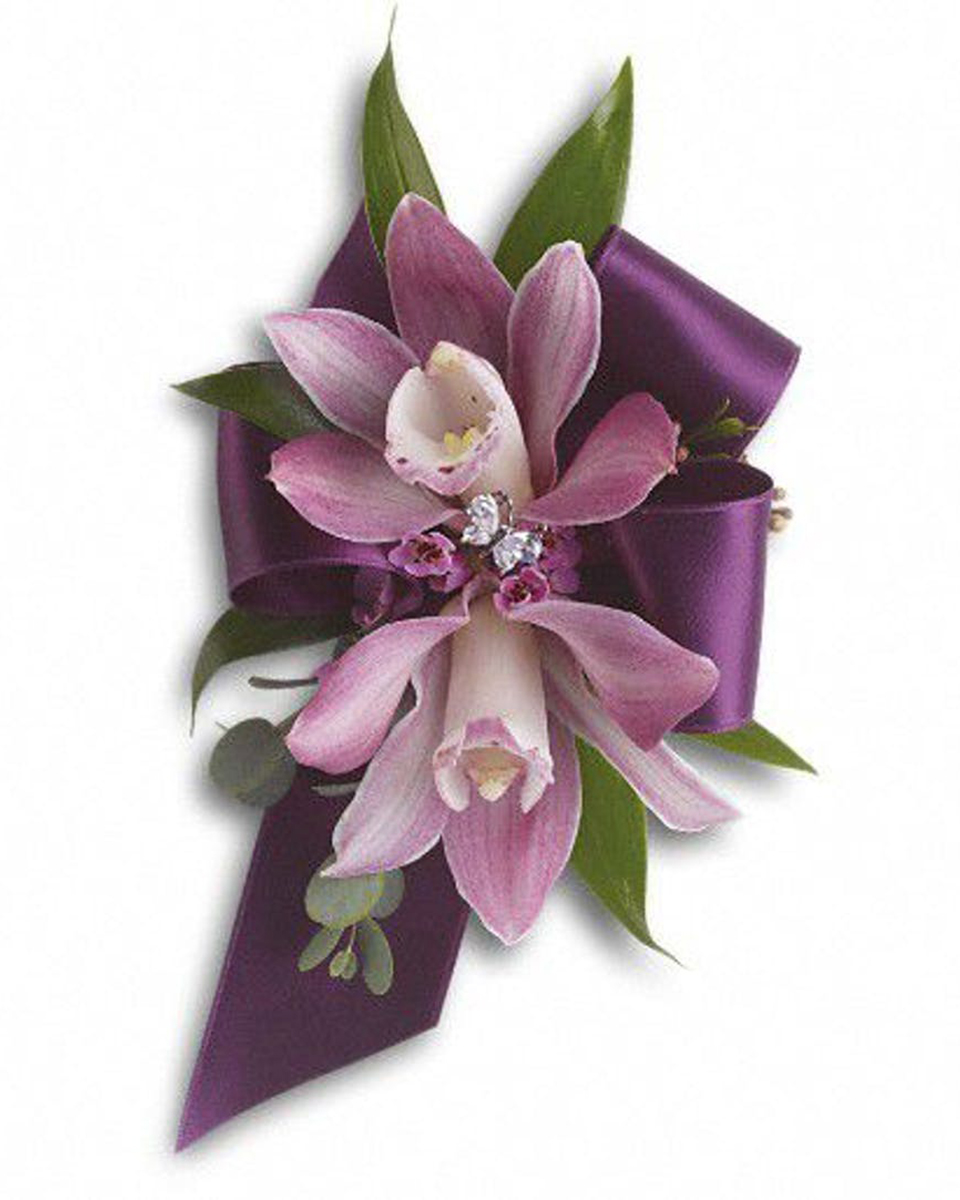 Purple Cym Corsage Standard  Purple Cymbidium Orchids, Rhinestones, Ruscus, Eucalyptus, and a backdrop Ribbon are exquisitely designed into a Corsage Wristlet.
DELIVERY: Every order is hand-delivered direct to the recipient. These items will be delivered by us locally, or a qualified retail local florist.