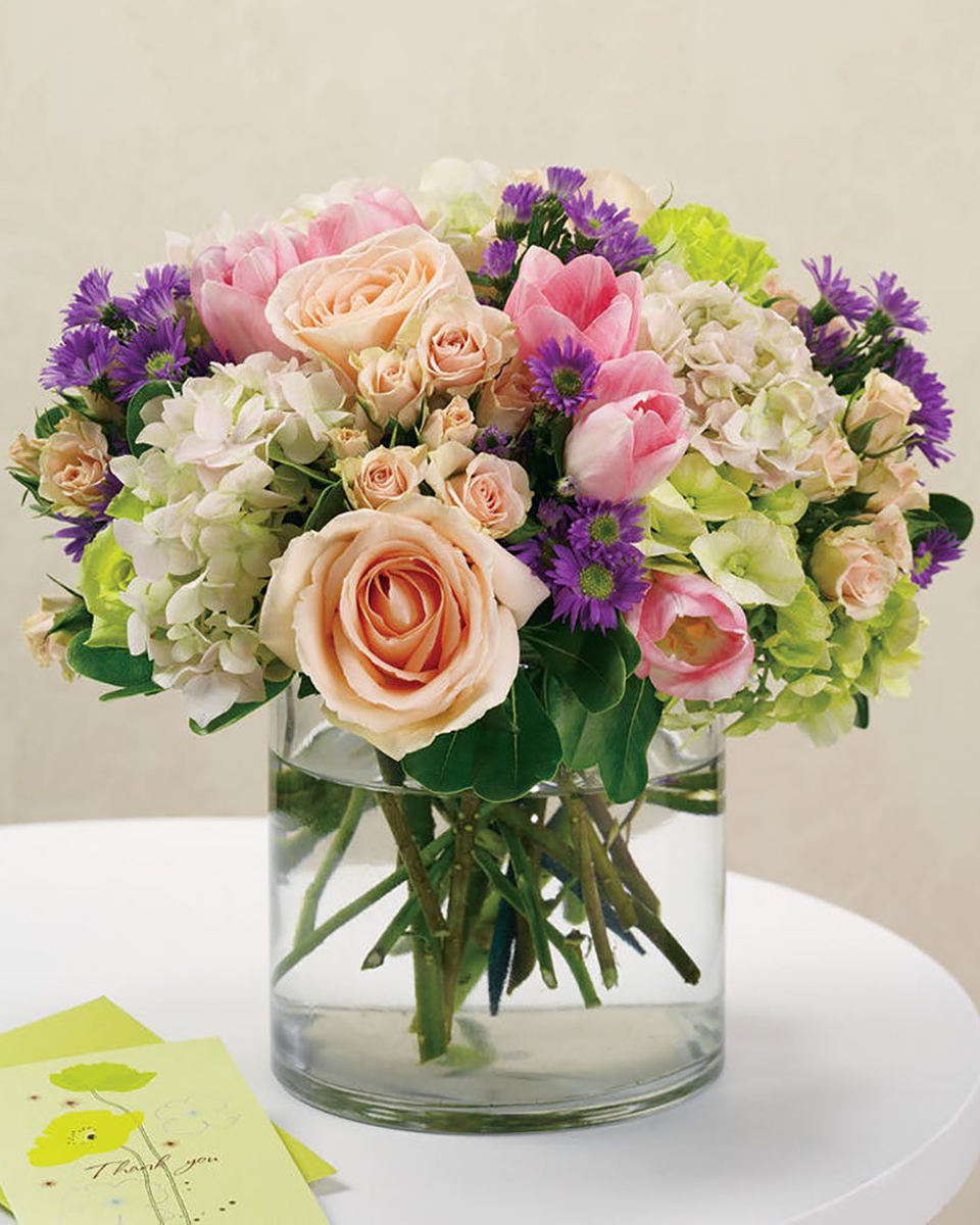 Classic Elegance Standard (6 in Cylinder) A 6 inch tall cylinder is filled with classic flowers. Roses, Spray Roses, Tulips, Hydrangeas, and Purple Monte Casino make this centerpiece appropriate for any occasion.
DELIVERY: Every order is hand-delivered direct to the recipient. These items will be delivered by us locally, or a qualified retail local florist.