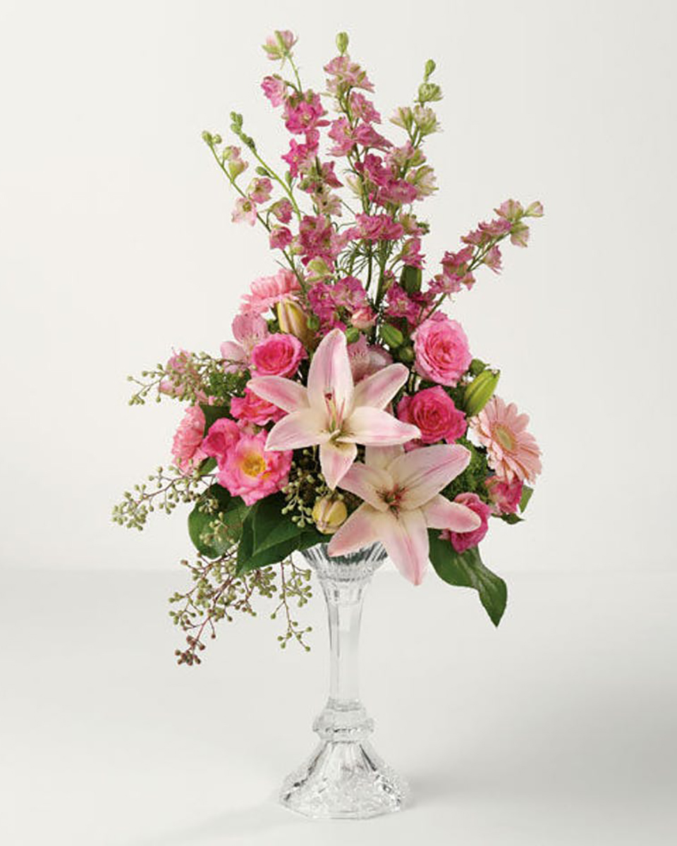 Pastel Pink Centerpiece Standard Pink Larkspur, Pink Lilies, Pink Gerberas, Light Pink and Hot Pink Roses, Pink Tulips, Lemon leaf, and Seeded Eucalyptus are Crafted into a Centerpiece Design in a Glass Pedestal Vase.
DELIVERY: Every order is hand-delivered direct to the recipient. These items will be delivered by us locally, or a qualified retail local florist.
