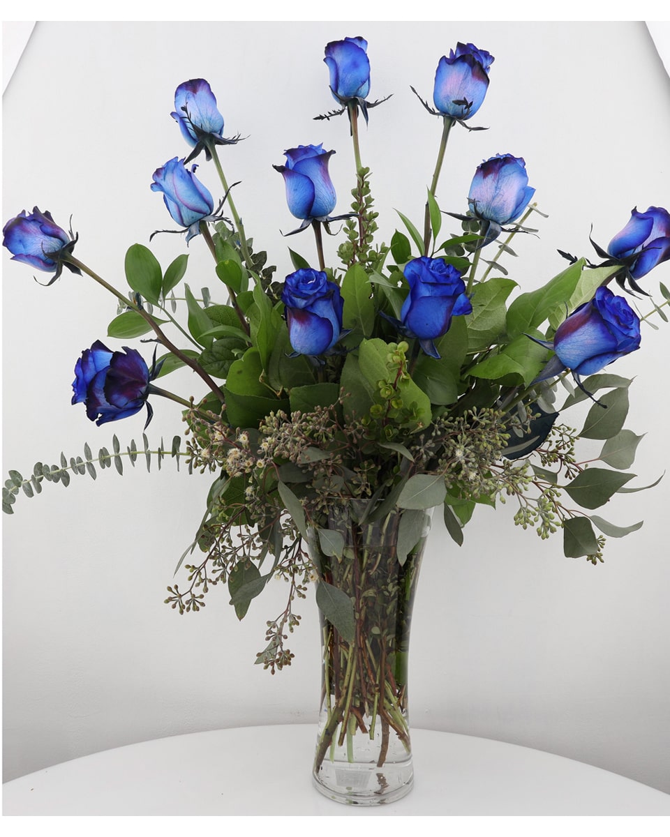 Blue Roses arranged in a Vase Standard-12 Blue Roses arranged in a Vase 12 unique, spectacular blue roses are arranged in a clear glass vase accompanied with greens and seasonal fillers.
DELIVERY: Every order is hand-delivered direct to the recipient. This item is only deliverable to local areas serviced by Allen’s Flower Market Stores.