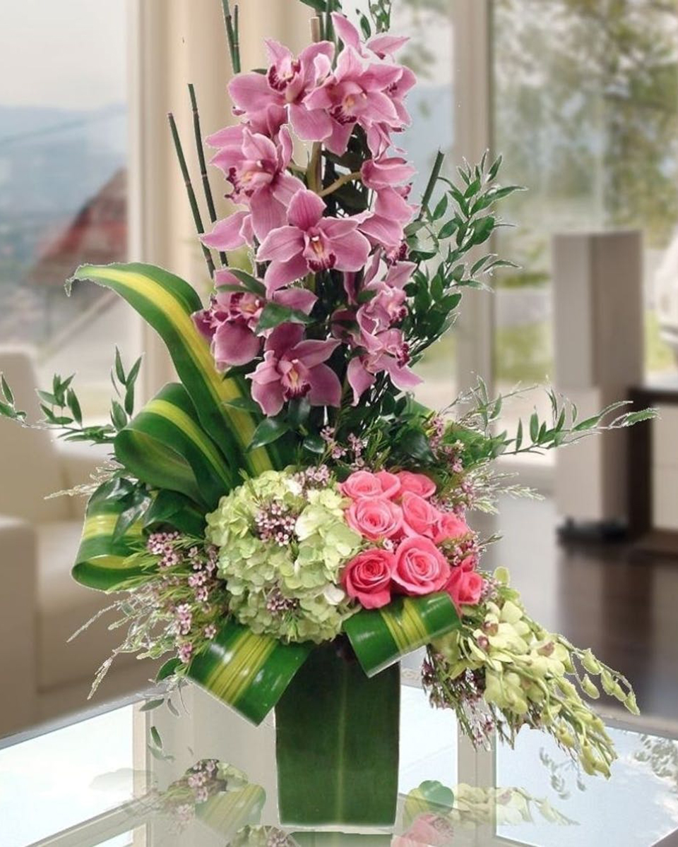 Dazzling Orchids Standard A Dazzling fresh flower arrangement of cymbidium orchids, pink roses,full-bloom hydrangea and exotic leaves. A perfect surprise celebration to be enjoyed and remembered!
DELIVERY: Every order is hand-delivered direct to the recipient. These items will be delivered by us locally, or a qualified retail local florist.