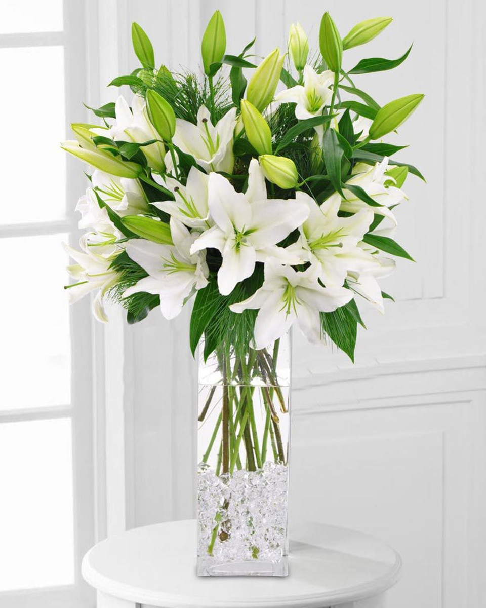 Winter White Lilies Standard A tall vase of Oriental lilies is on everyone’s holiday list. Perfect for winter parties or holiday décor.
DELIVERY: Every order is hand-delivered direct to the recipient. These items will be delivered by us locally, or a qualified retail local florist.