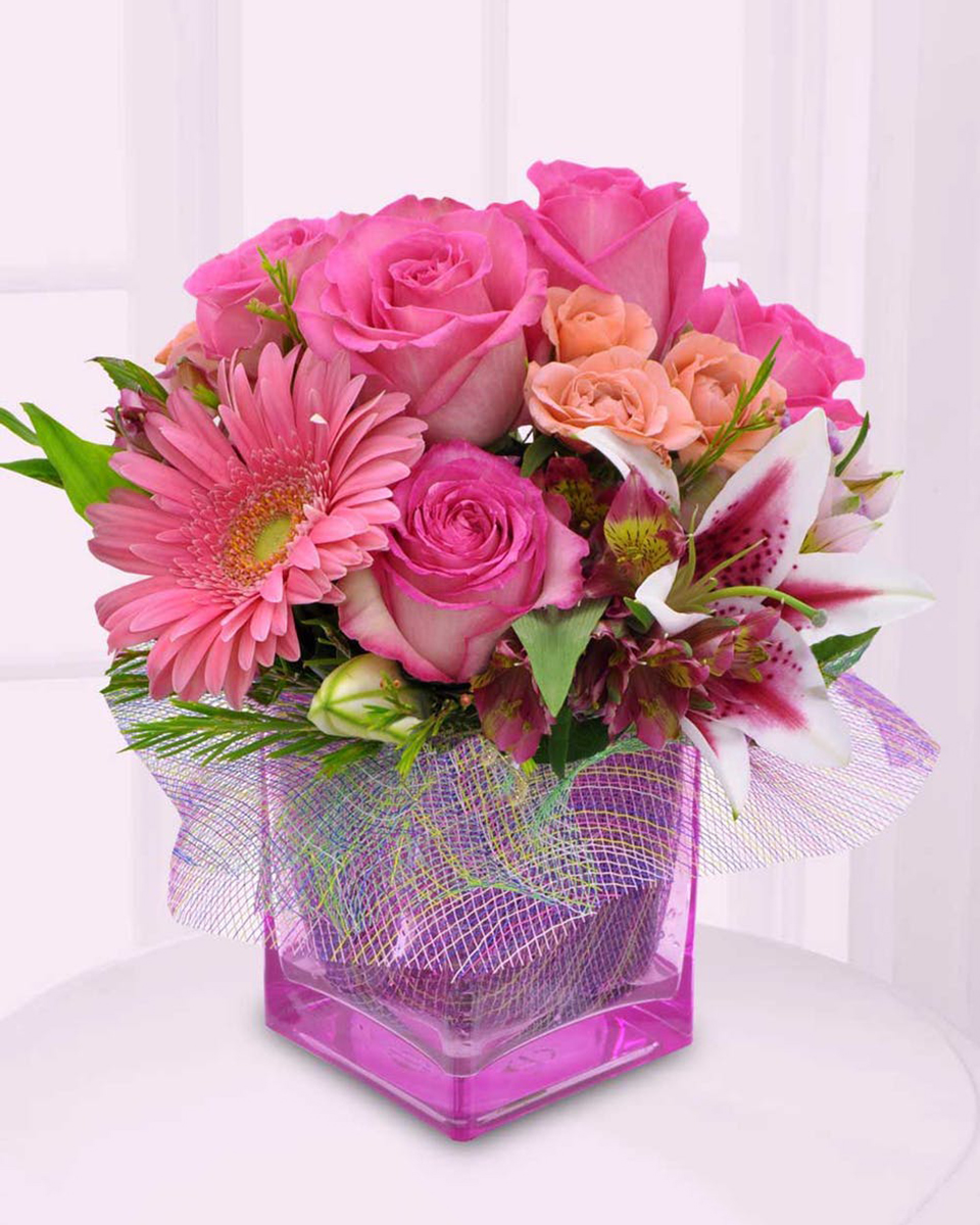 Gerbera Greatness Standard (4 x 4 in cube) Gerbera Daisies, Alstroemaria, Starfighter Lillies, Roses, Spray Roses, and assorted greens arranged in a Pink Rectangle Glass Block.
DELIVERY: Every order is hand-delivered direct to the recipient. These items will be delivered by us locally, or a qualified retail local florist.