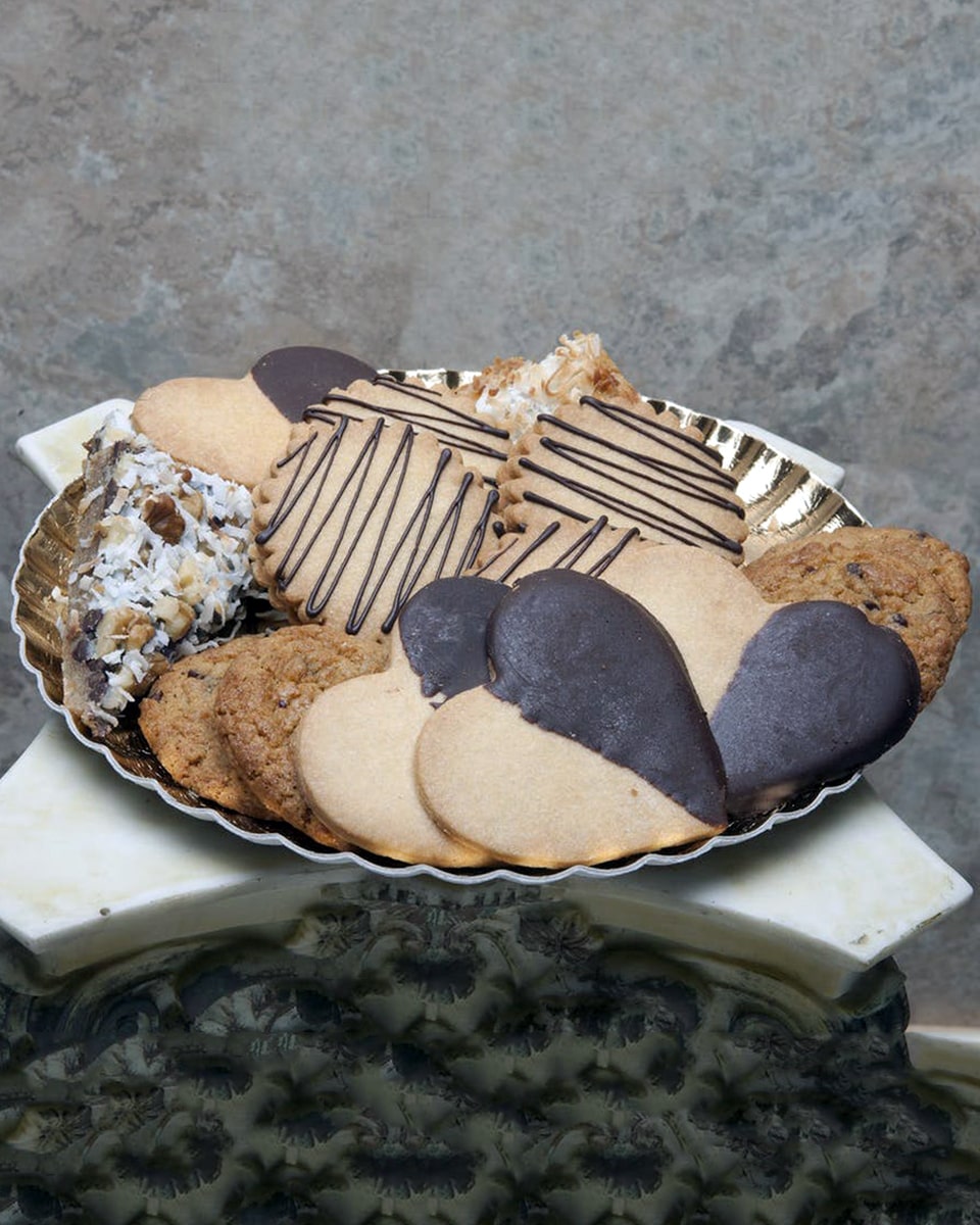 Chocolate is the Answer Cookie Assortment Standard-16 Cookies These Cookies are for the Chocolate Lover in all of us. Chocolate Dipped Heart Cookies, Chocolate Chip Cookies, Almond Biscotti, Coconut Bars, Chocolate Chip Bars, Walnut Bars, and Chocolate-Ganache filled Butter Cookies come in this tantalizing assortment. These Cookies are daily baked in Long Beach to ensure Freshness and quality.
DELIVERY: Every order is hand-delivered direct to the recipient. These items will be delivered by us locally, or a qualified retail local florist.