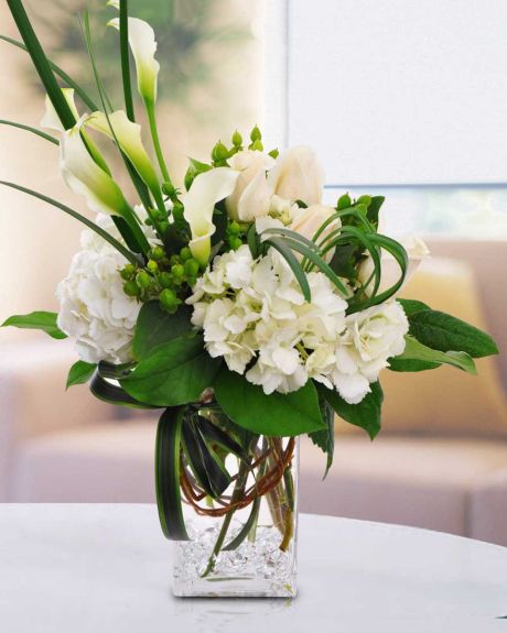 White wizard-Beautiful White Calla Lilies, White Hydrangea, White Roses, Green Hypericom, Lily Grass, and assorted Green Foliage comprise this vased, elegant masterpiece .-Arrangement
