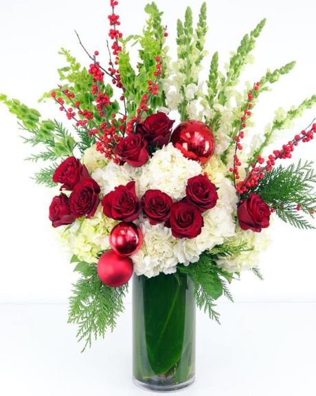 Deck the Halls-featuring lush white hydrangea, long-stem red roses, white stock, belles of Ireland, REAL ilex berries and more!-Christmas arrangements