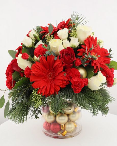Gold Coast Christmas,- A festive and glorious holiday bouquet of holiday white roses, red dianthus, gold ornaments nestled in scented holiday evergreens.  -CHRISTMAS ARRANGEMENT