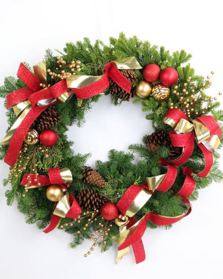 Joyous Holiday Wreath-Nothing says the holidays like a holiday front door wreath. Sparking with elegance, this evergreen wreath is decorated with vibrant red and gold ornaments,  gold ilex festive ribbon and pinecones. -Christmas wreaths