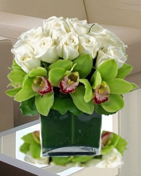 White Roses and Orchids-Elegant white garden roses nestled amid exotic green cymbidium orchids create a very sophisticated and stunning gift to recognize any occasion.-Roses